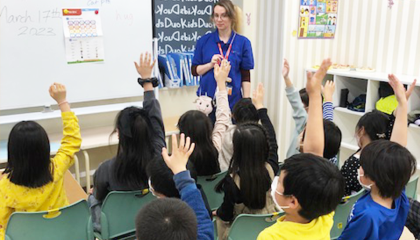 Students raise their hands during a Kids Duo class