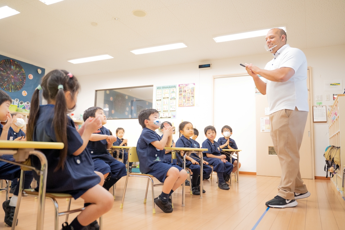 Teacher instructs class of attentive students