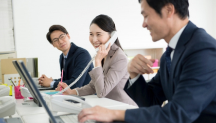 Three people work in an office